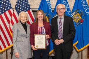 Kelly Behnke financial literacy award with Governor Evers