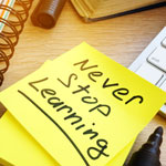 Post it note with quote of never stop learning